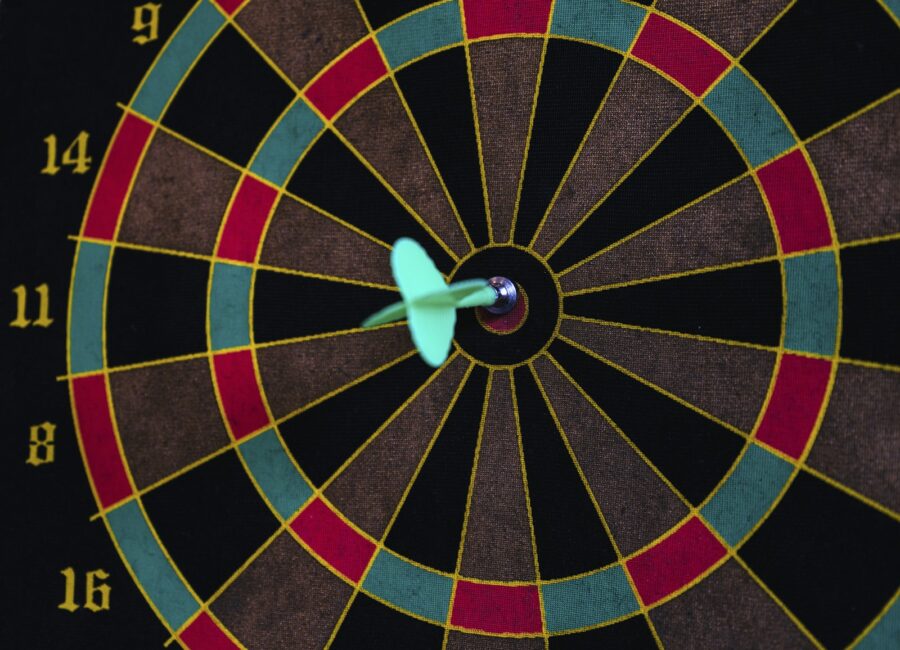 Dartboard with a dart in the bullseye